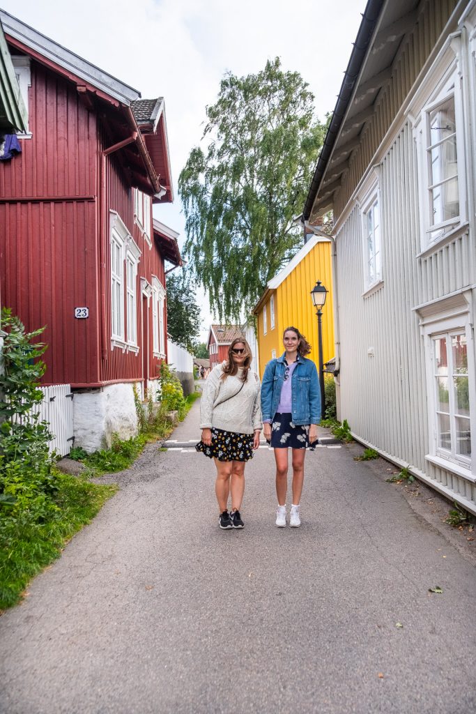 Two girls in the old part of Tønsberg Norway with colorful houses
