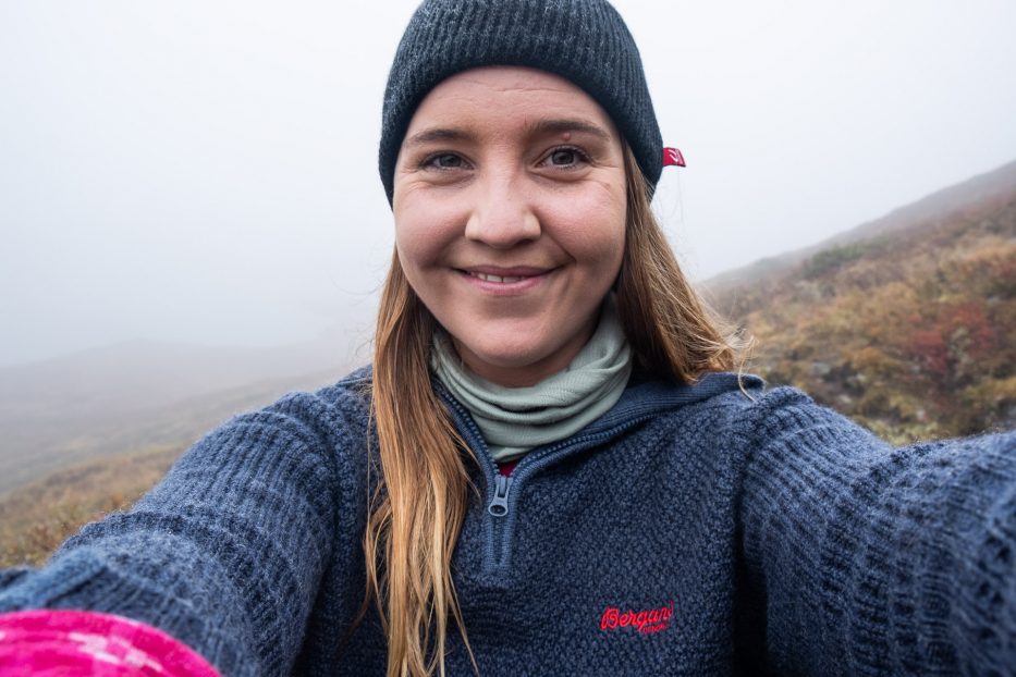 girl taking selfie in a foggy mountain landscape