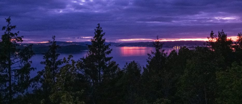 Sunset over trees and water in Norway