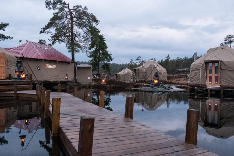 view over canvas telemark with a pier and yurts by the waterfront