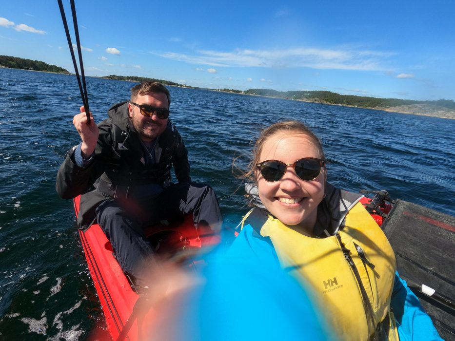 mann og kvinne tar selfie ombord på en trimaran