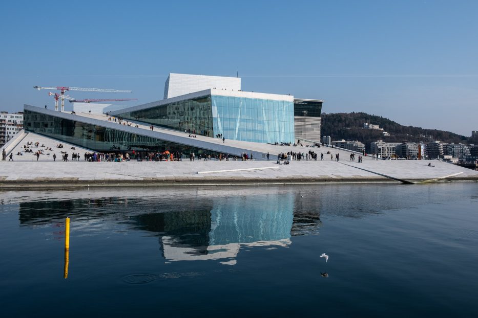 the opera house in oslo with reflections in the water