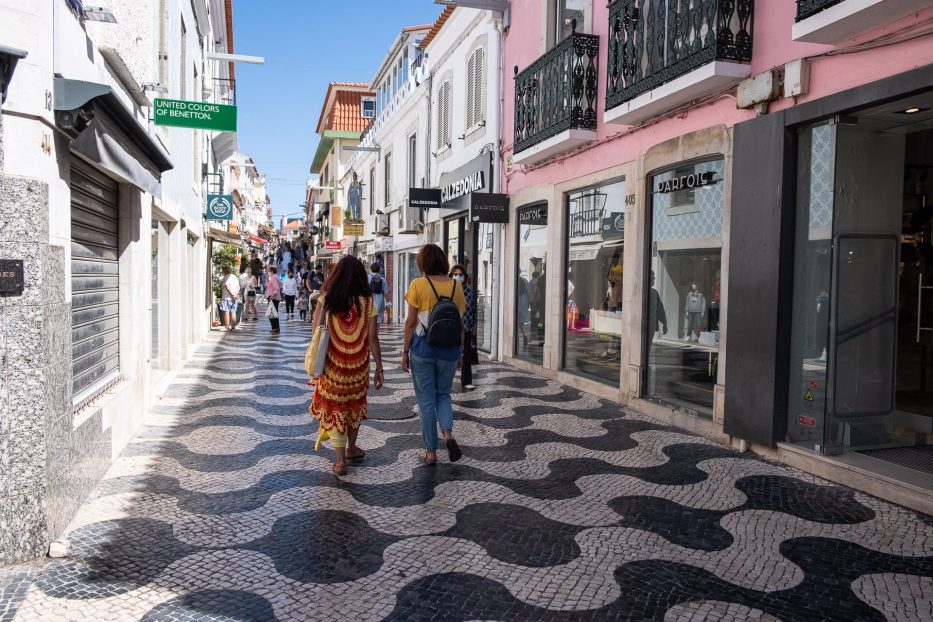 to women walking in the cobblestone pedestrian area of cascais city centre