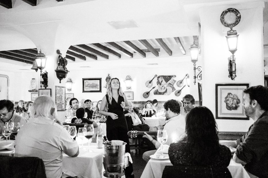 woman singing at a fado restaurant in lisbon