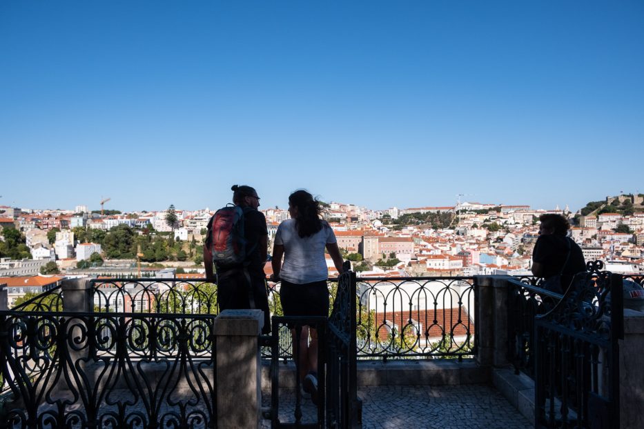 man and woman looking out over lisbon together