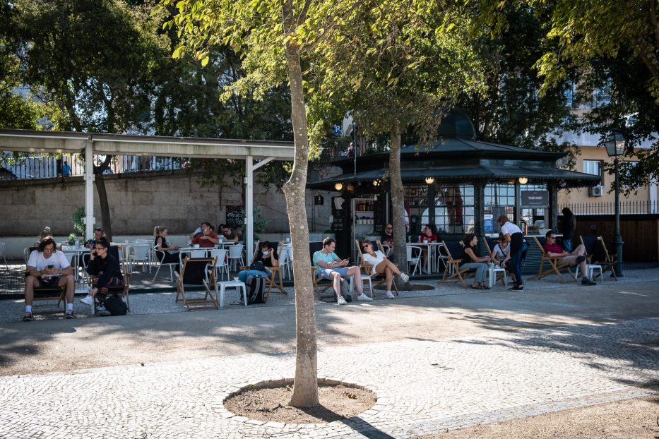 people relaxing in the shade in lisbon