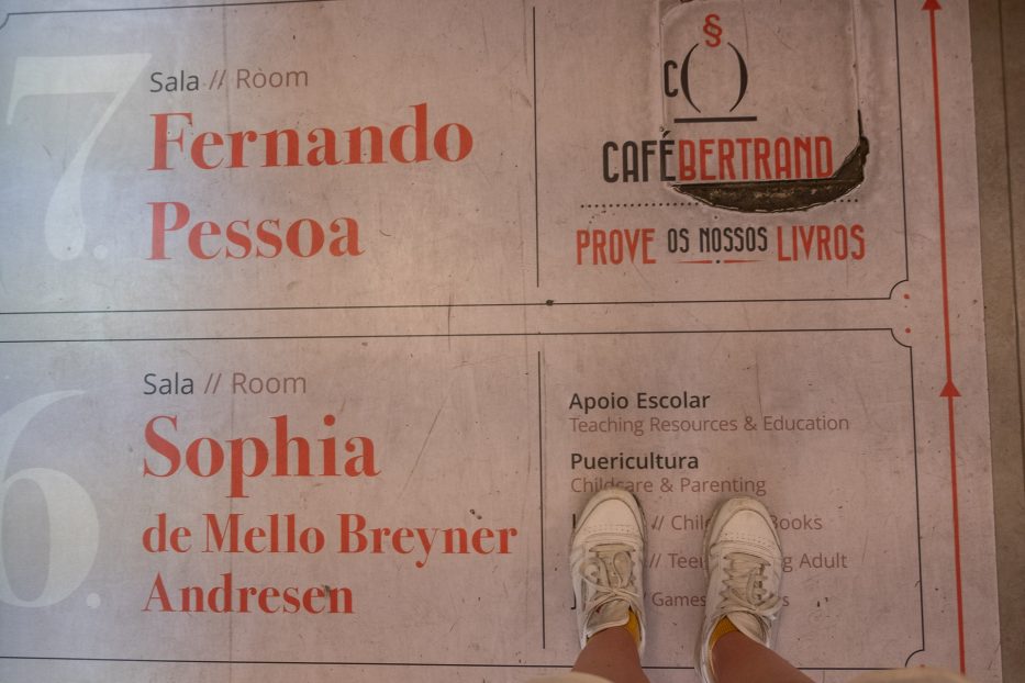 a pair of Reebok shoes standing at the entry of café Bertrand in lisbon