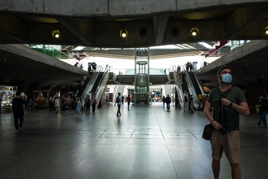 man standing at oriente station in lisbon