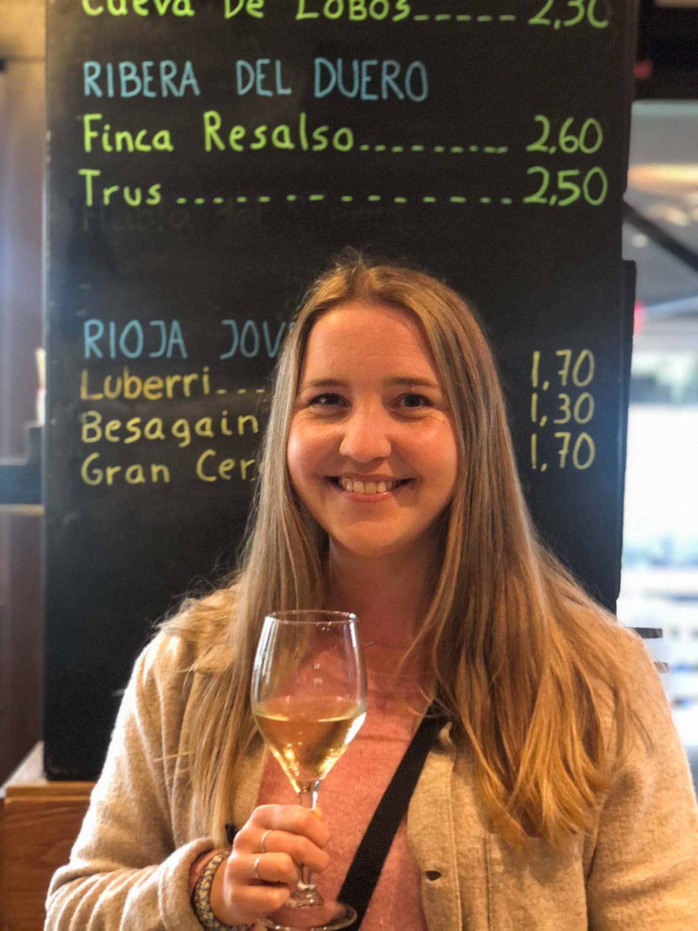 smiling woman holding a glass of wine