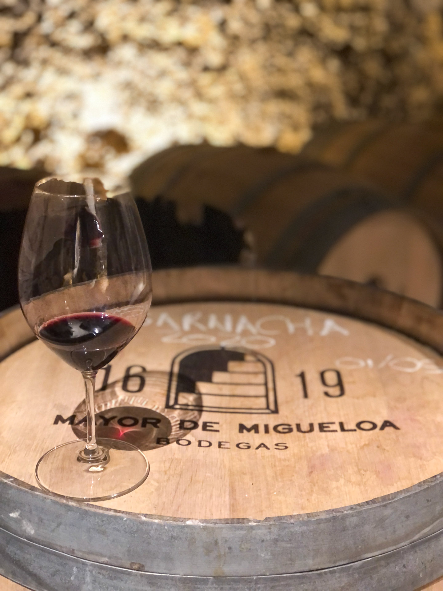 detail of a wine glass on a wine barrel