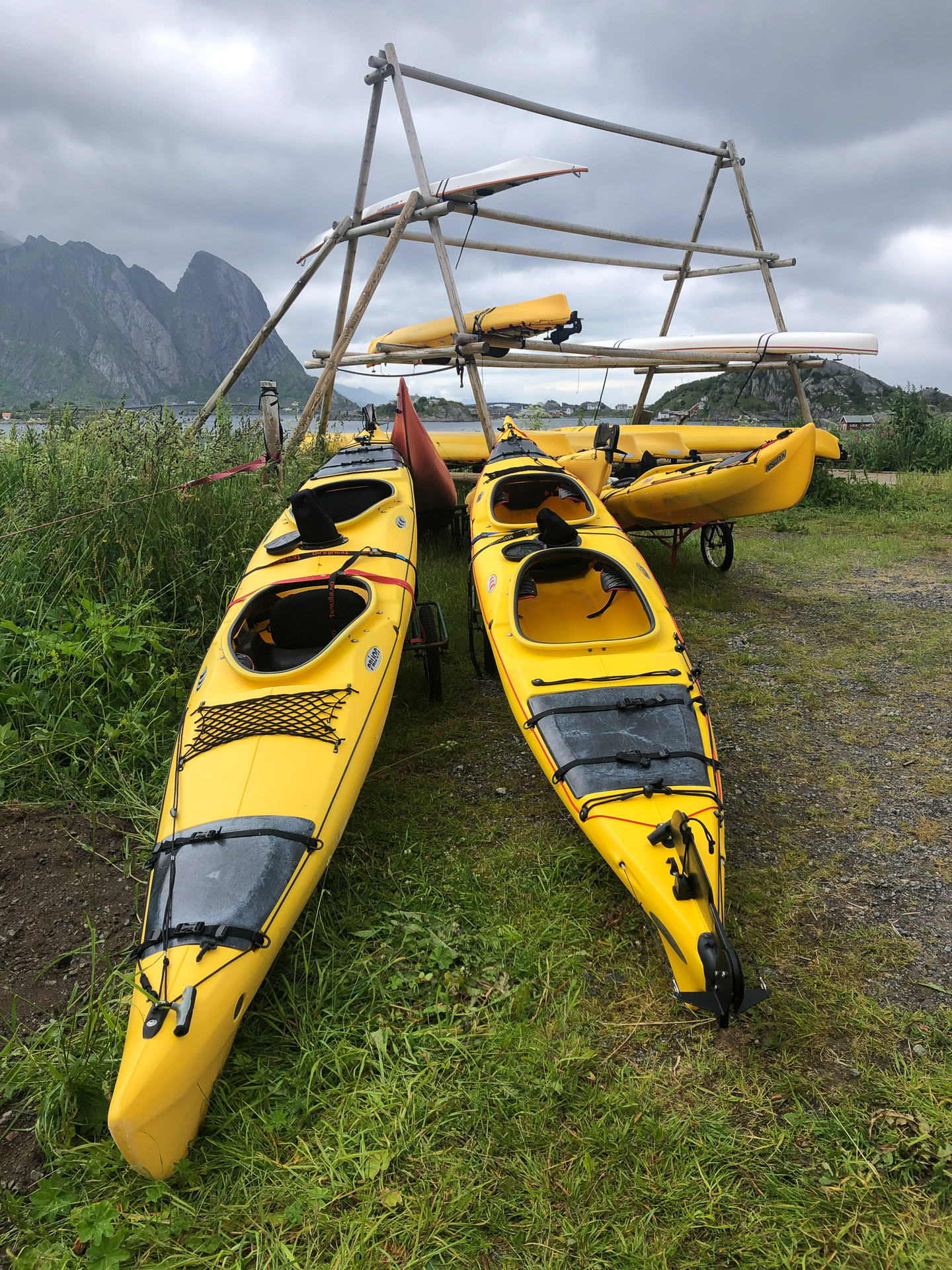 yellow kayaks on green grass in lofoten