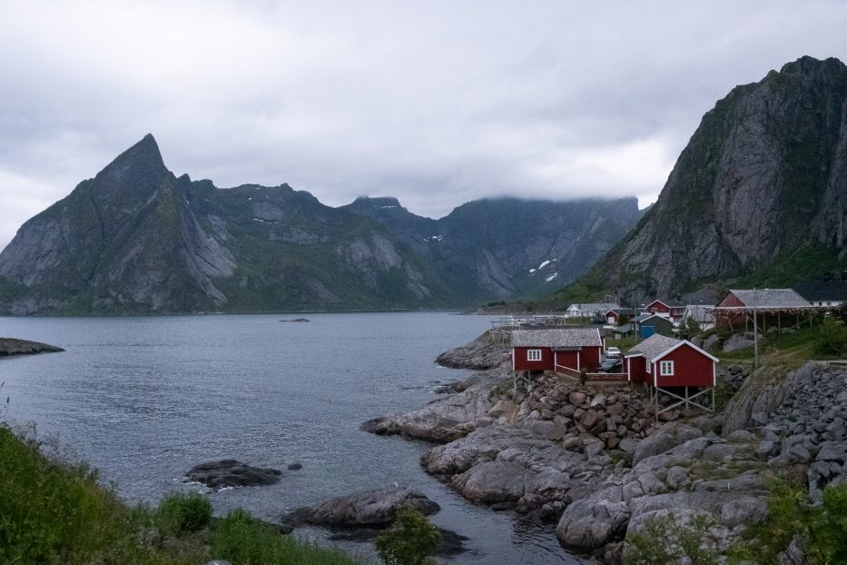 red houses and tall mountains in lofoten on a rainy day