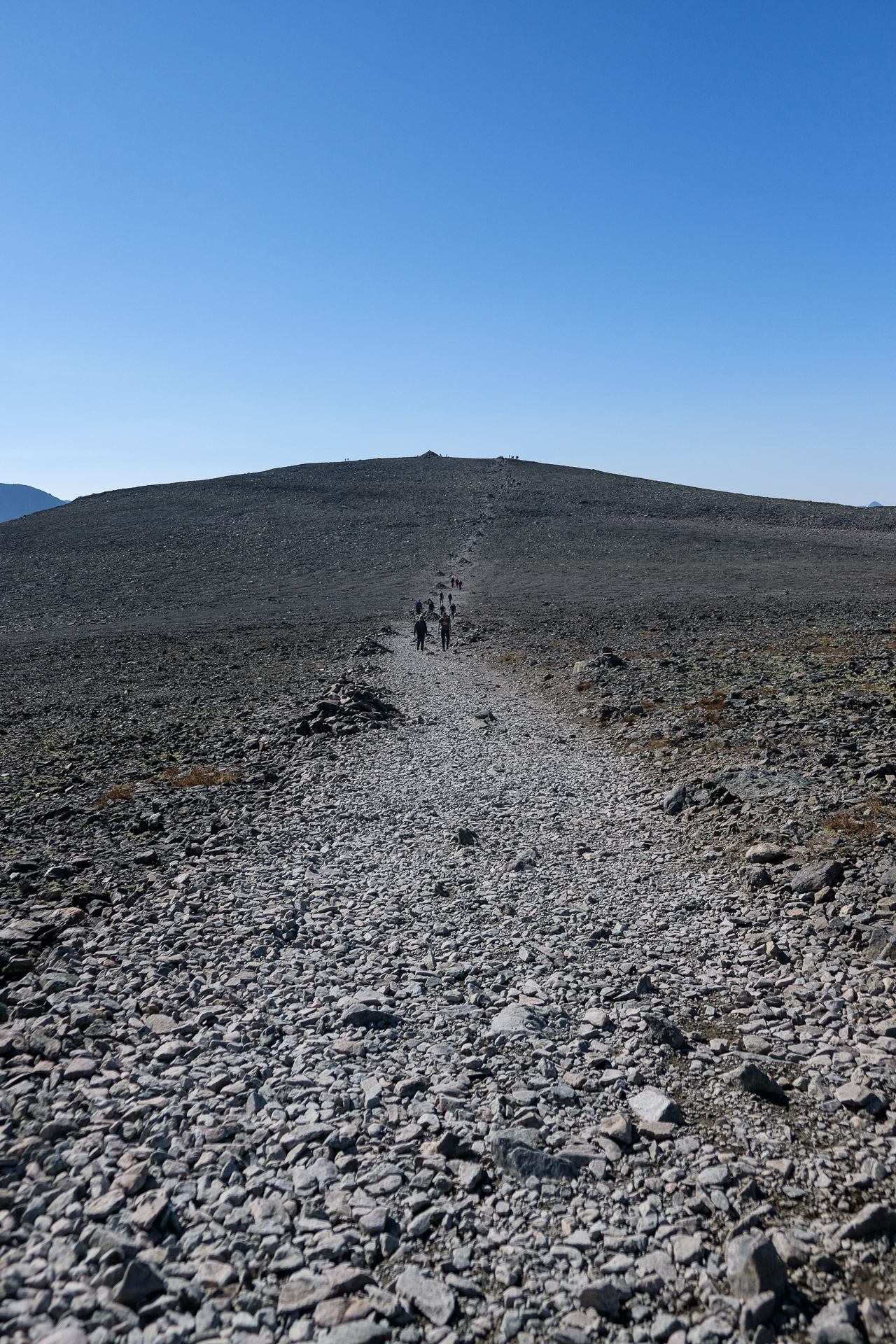 people walking on a gravel road