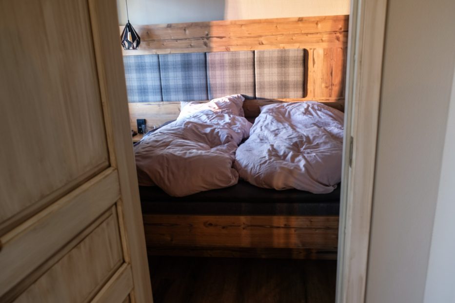 a bedroom with sunlight from a window