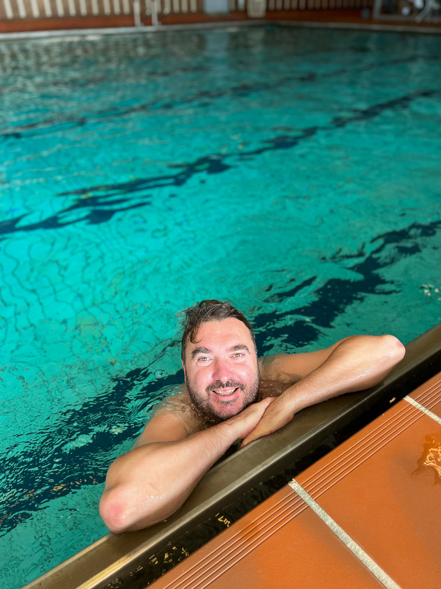 man smiling in a swimming pool