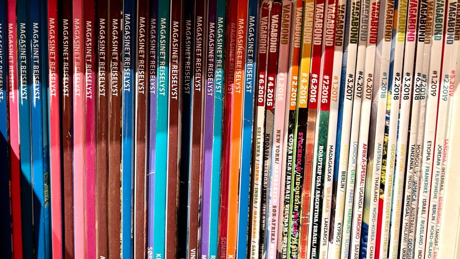 loads of travel magazines in different colours