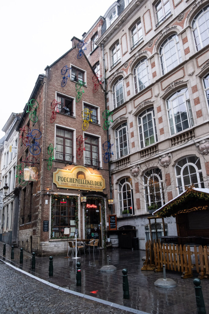 building in the street of brussels with bikes in different colours mounted on the facade