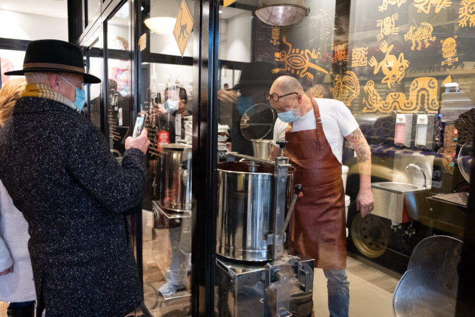 man steering in a big pot of hot chocolate