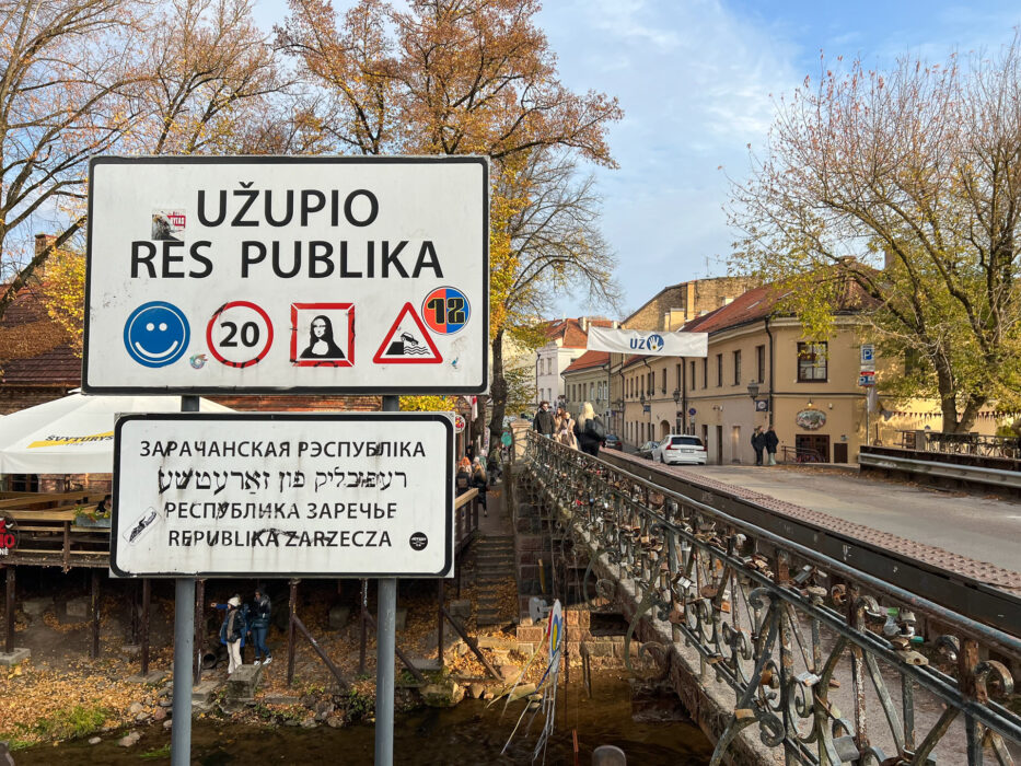 the entrance to the independent republic of uzupis in vilnius lithuania bridge and signs