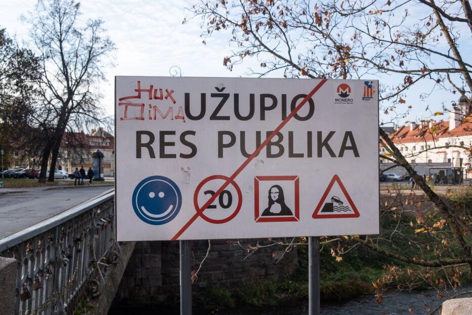 exit of uzupis with the sign crossed over and bridge in the background