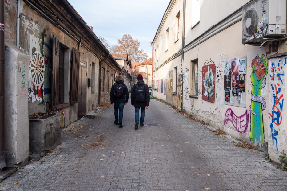 two people walking in the streets of uzupis vilnius lithuania