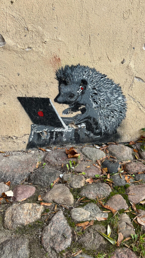 streetart of a hedgehog on a laptop