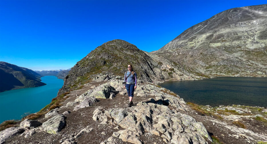 a smiling woman on top of besseggen