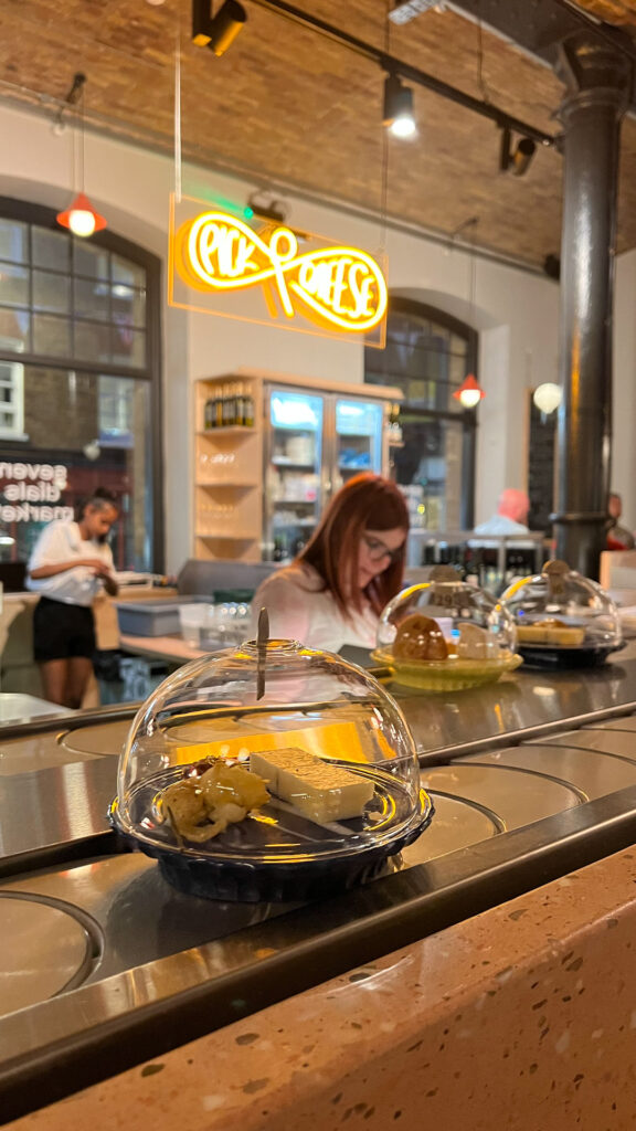 a tray with cheese on the conveyer belt at pick & cheese in london