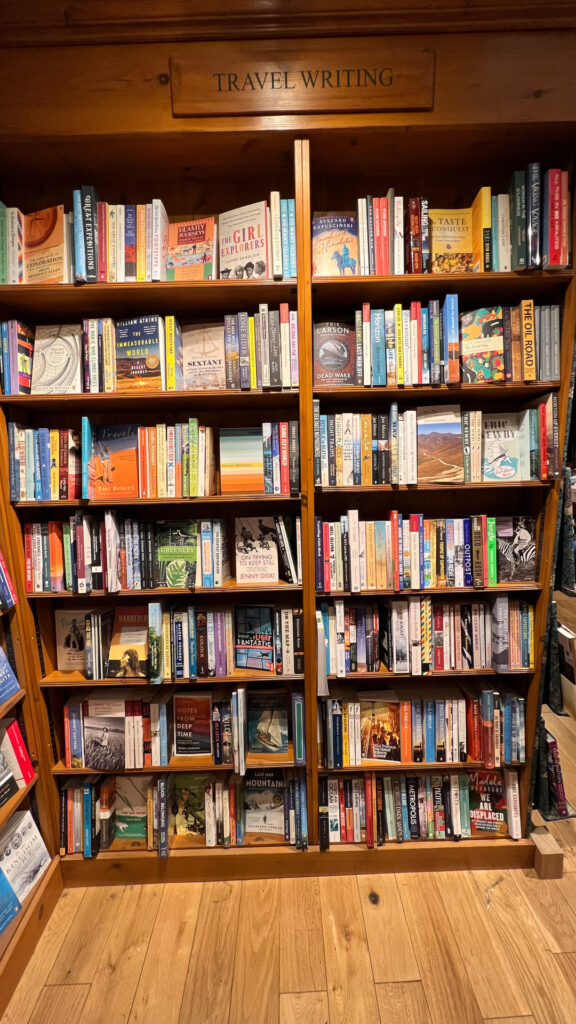 the travel writing section inside daunts books in london