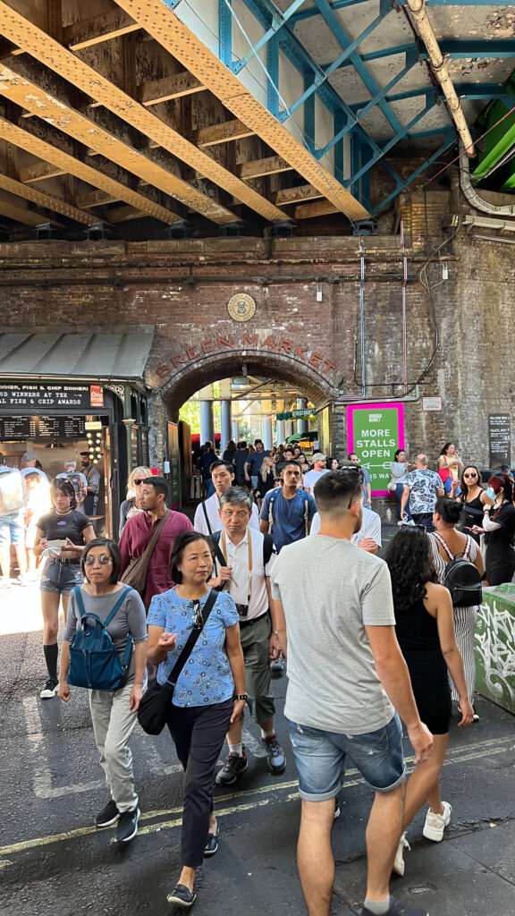 people in summery clothes at borough market