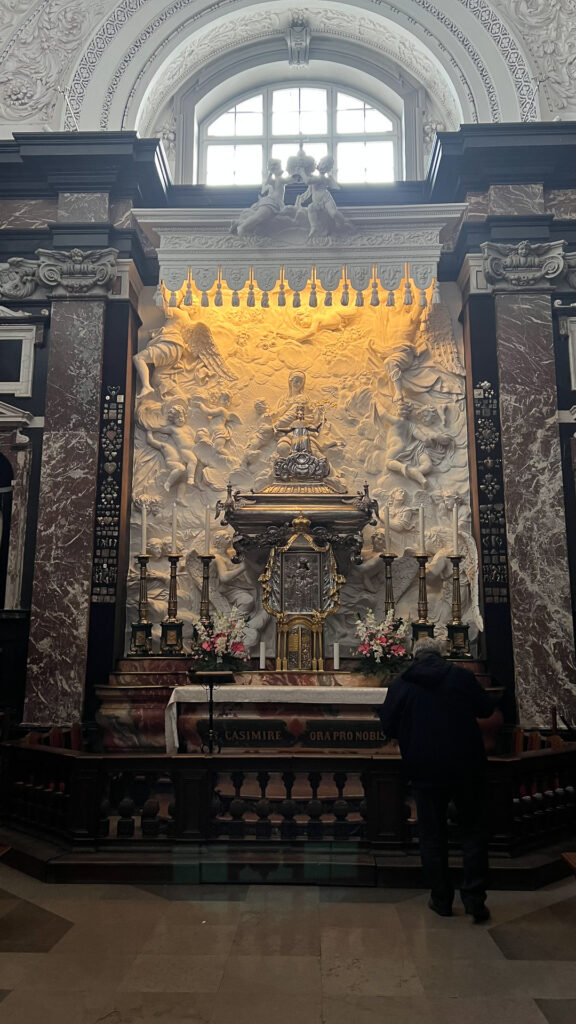 details from inside a church in vilnius, a man in front of an altar