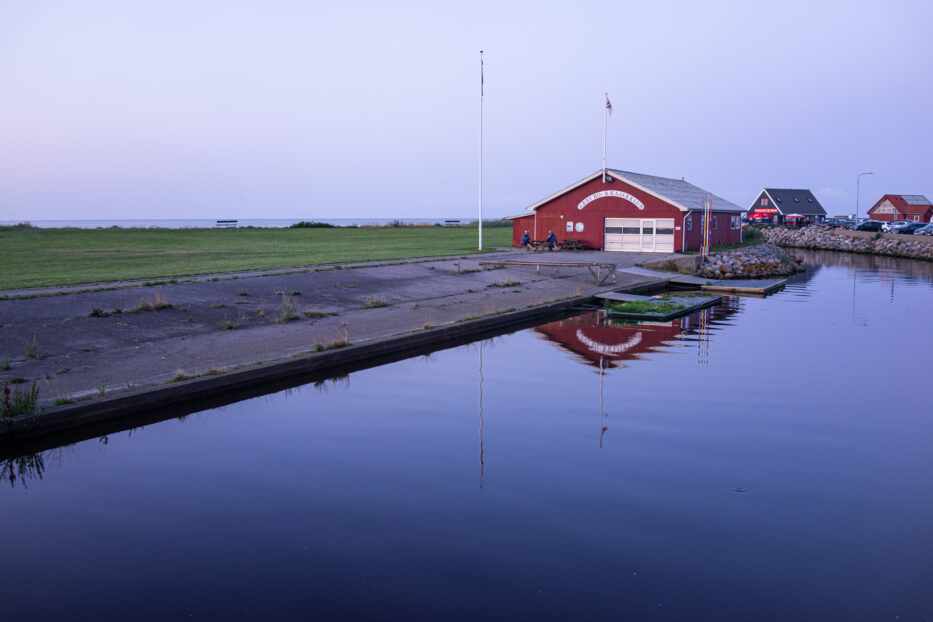 sunset over the red clubhouse of sæby roklub