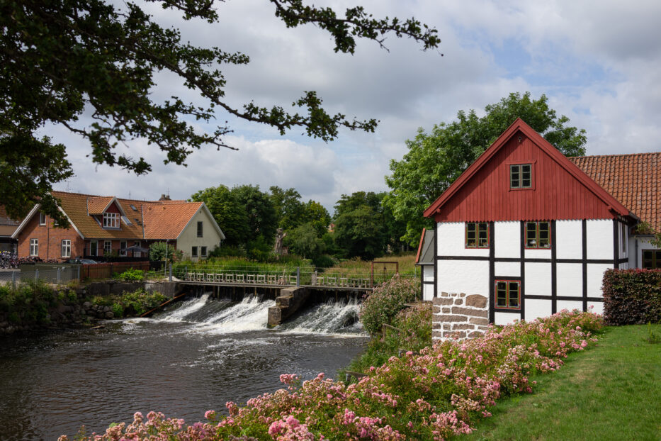 a waterfall and cute houses in sæby denmark