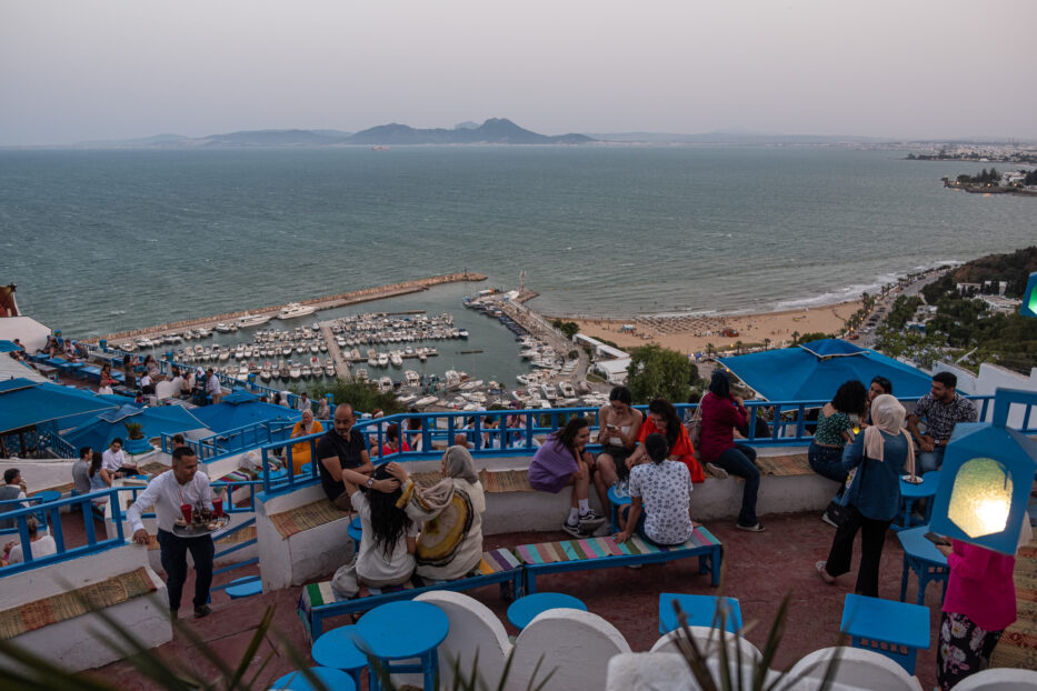 people relaxing at Café des Delices with a gorgeous view over the sea