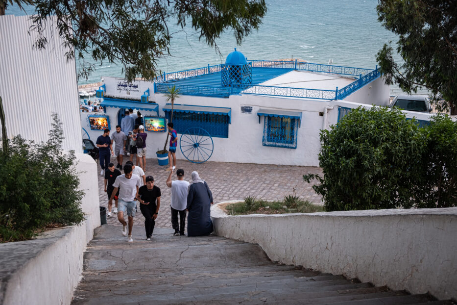 a group of people in the stairs towards cafe des delices