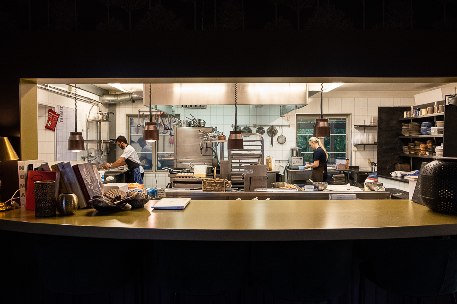 a man and a woman working inside the kitchen at Katrinelund Gästgiveri & Sjökrog preparing breakfast