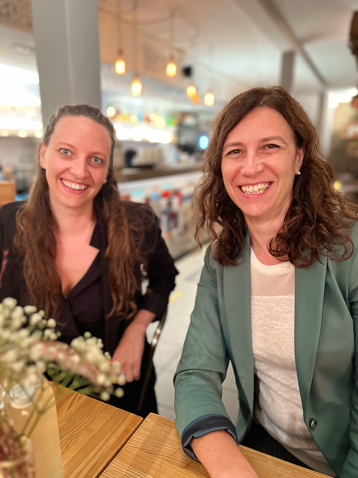 two smiling ladies at restaurant gro