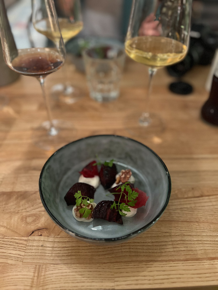 a round bowl with beets and cheese