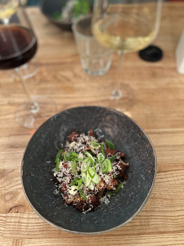 a round bowl with a cauliflower dish