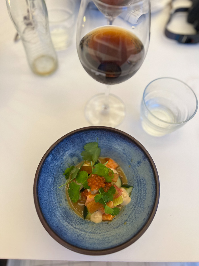 a round blue bowl with ceviche