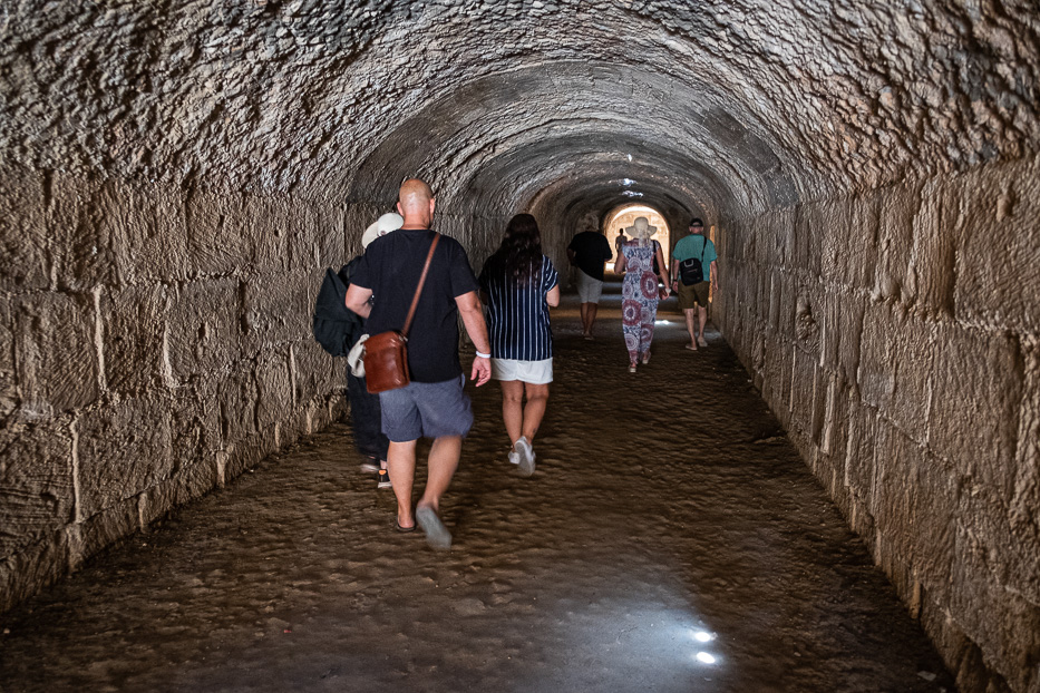 people walking underground in a tunnel in el jem