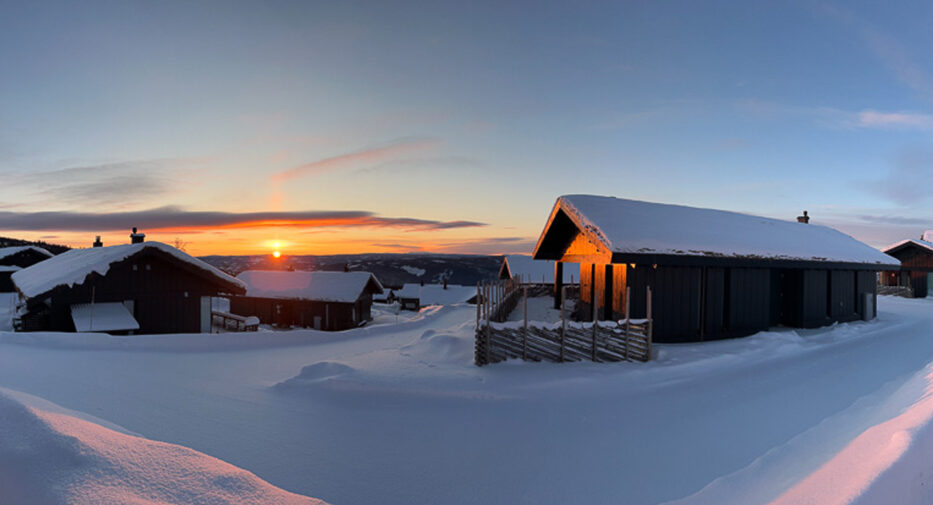 solnedgang over snølandsskap og hytter