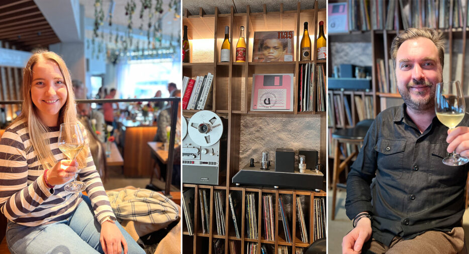 smiling woman and man holding glasses of wine and old LP's in a restaurant in oslo