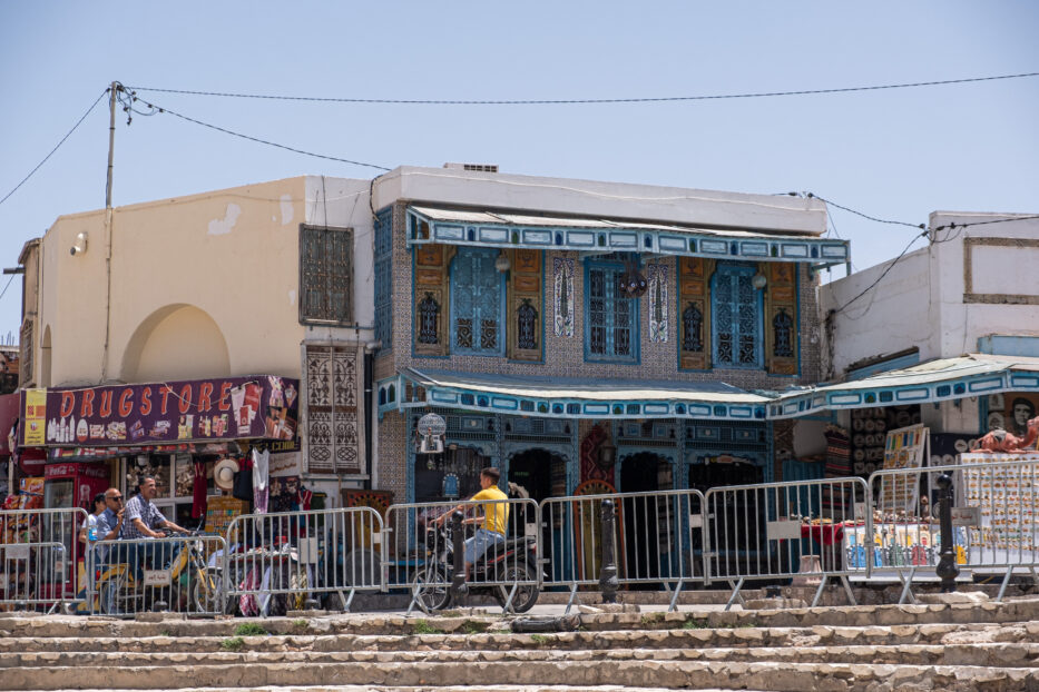 a kid in a yellow t-shirt on a motor bike in el jem