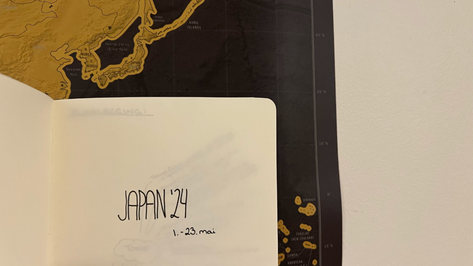 bok med teksten japan 24 holdt opp foran et kart av japan